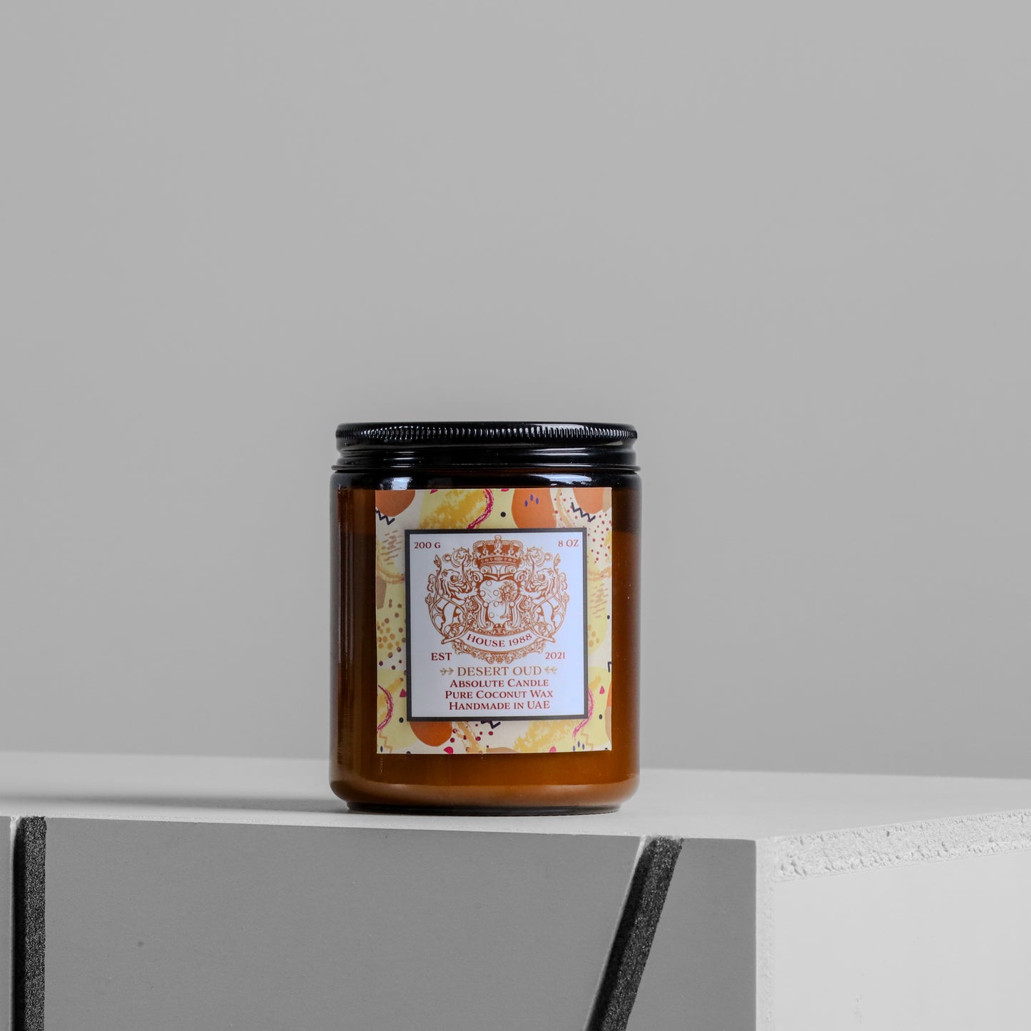 House 1988 Desert Oud candle, 200g amber jar with black lid and beige patterned label, coconut wax