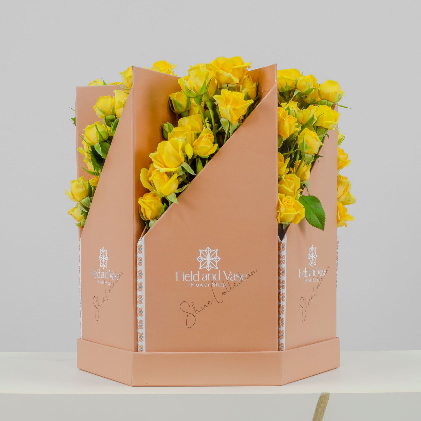 Medelya peach flower bag with angled V opening filled with yellow baby roses